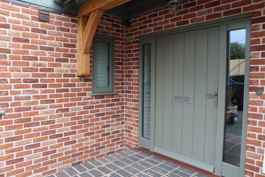 Contemporary grey solid panel door with glass side panels