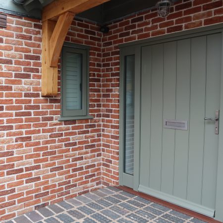 Contemporary grey solid panel door with glass side panels