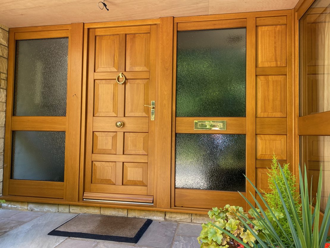 hard wood stained entrance door with glass side panels