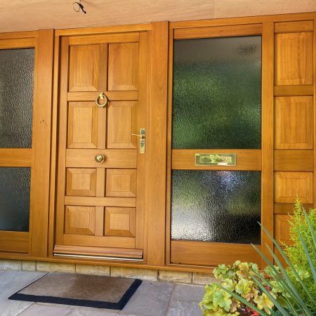 hard wood stained entrance door with glass side panels
