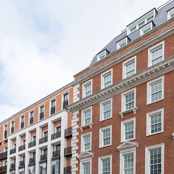 A grand red-brick building with white sash windows and white detailing.