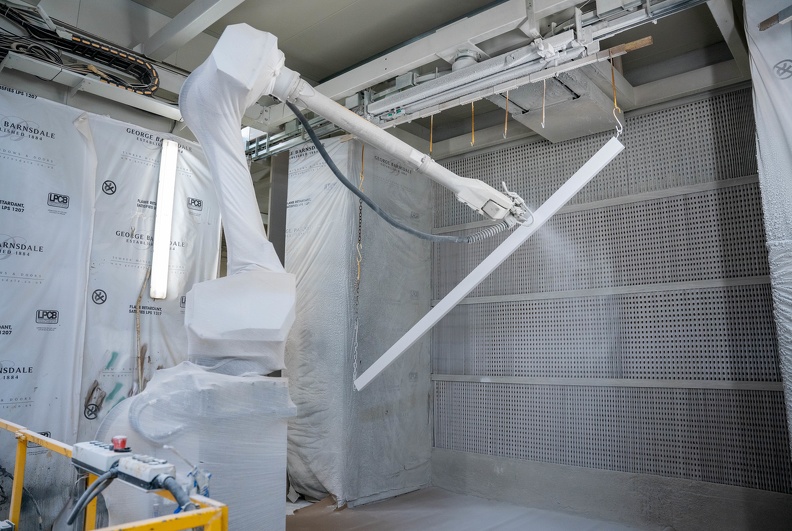 Paint robot sprating a piece of timber