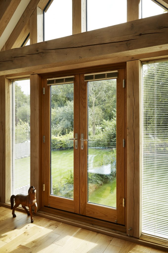 beautiful stained timber french doors in an oak framed house