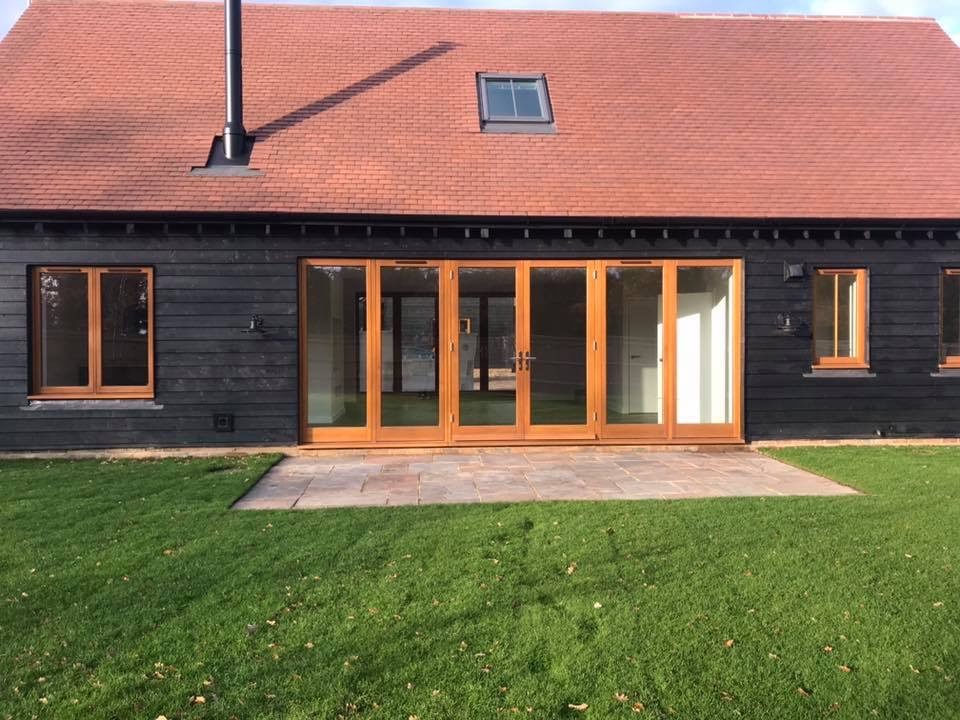 large set of stained timber french doors in a barn conversion